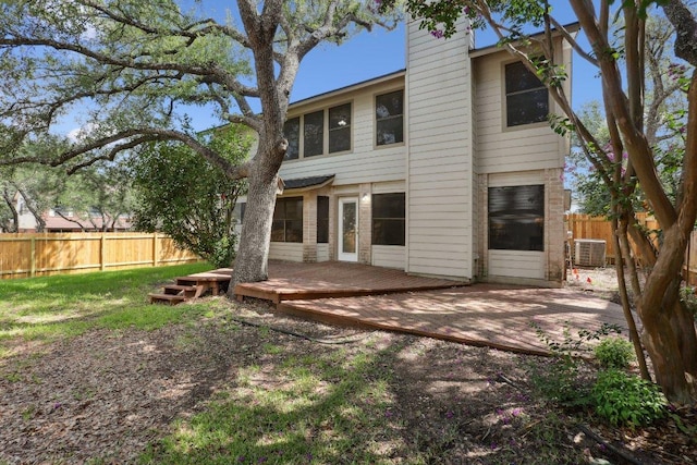 12706 Shemya Cv, Austin, TX 78729 - rear view of house with a fenced backyard, a wooden deck, and a chimney