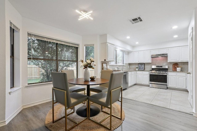 12706 Shemya Cv, Austin, TX 78729 - dining area featuring light wood-style flooring and recessed lighting