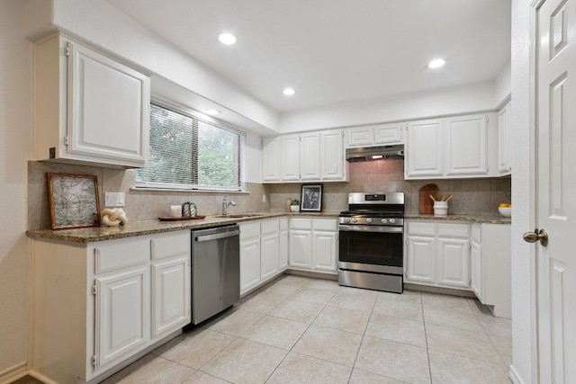 12706 Shemya Cv, Austin, TX 78729 - kitchen featuring stainless steel appliances, under cabinet range hood, tasteful backsplash, white cabinetry, and recessed lighting