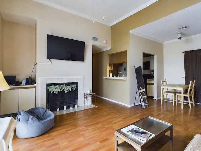 2804 Rio Grande St Unit 308, Austin, TX 78705 - living area with ornamental molding, wood finished floors, and a fireplace