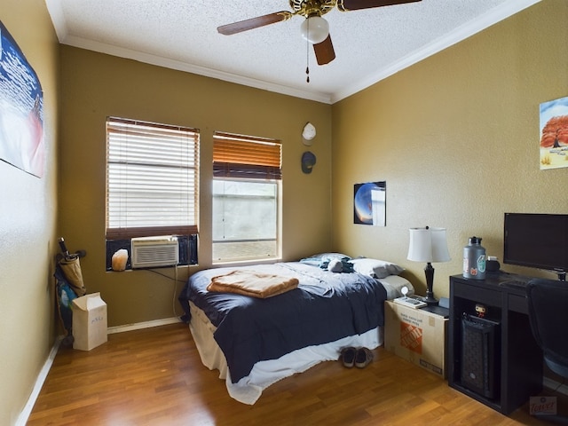 2804 Rio Grande St Unit 308, Austin, TX 78705 - bedroom with wood finished floors, ornamental molding, a textured ceiling, ceiling fan, and cooling unit