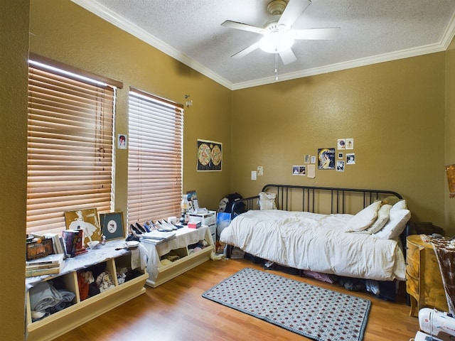 2804 Rio Grande St Unit 308, Austin, TX 78705 - bedroom featuring a textured ceiling, wood finished floors, crown molding, a textured wall, and a ceiling fan