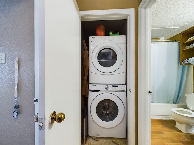 2804 Rio Grande St Unit 308, Austin, TX 78705 - laundry room with stacked washer / drying machine, a textured ceiling, and wood finished floors