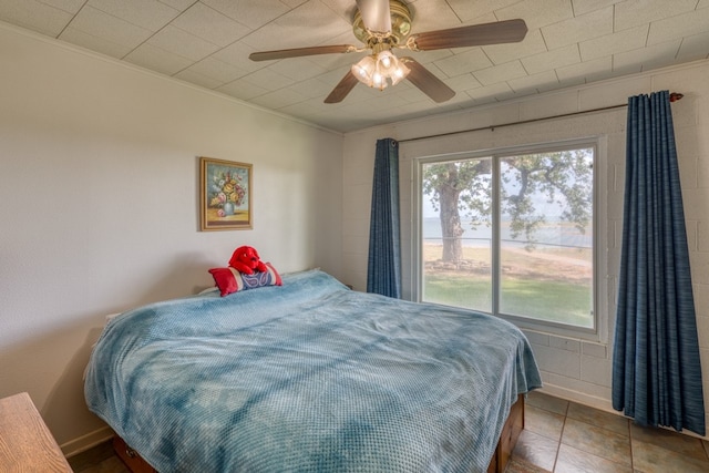 106 Chuckwagon, Burnet, TX 78611 - tiled bedroom featuring ornamental molding and a ceiling fan