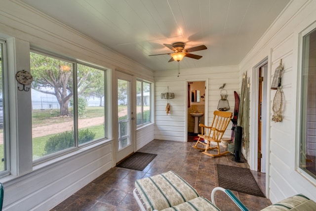 106 Chuckwagon, Burnet, TX 78611 - sunroom featuring stone finish flooring, ornamental molding, and wooden walls