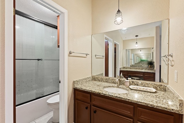 1602 Plateau Rdg, Cedar Park, TX 78613 - bathroom with vanity, bath / shower combo with glass door, and a textured wall