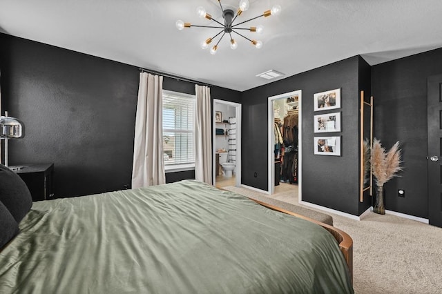 244 Fabion St, Kyle, TX 78640 - bedroom featuring carpet, a walk in closet, a chandelier, and a closet