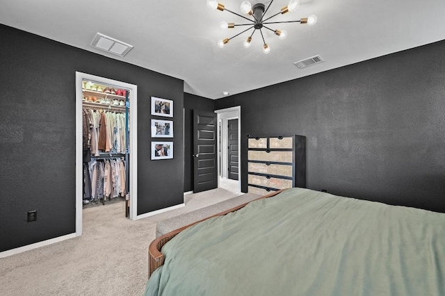 244 Fabion St, Kyle, TX 78640 - bedroom with carpet flooring, a chandelier, a spacious closet, and a closet