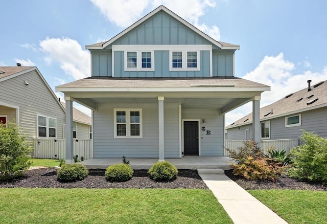 244 Fabion St, Kyle, TX 78640 - view of front facade featuring a porch, board and batten siding, and a front yard