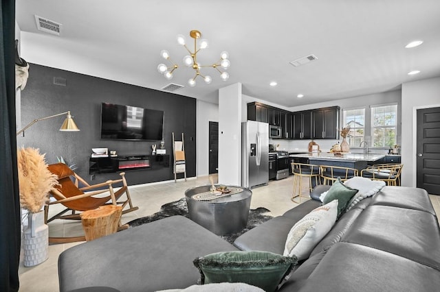 244 Fabion St, Kyle, TX 78640 - living room featuring recessed lighting and a chandelier