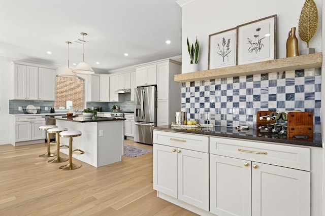 8902 Rustic Cv, Austin, TX 78717 - kitchen with stainless steel fridge, tasteful backsplash, a kitchen breakfast bar, dark countertops, and recessed lighting