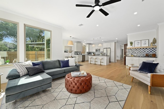 8902 Rustic Cv, Austin, TX 78717 - living area featuring ornamental molding, light wood-type flooring, a ceiling fan, and recessed lighting