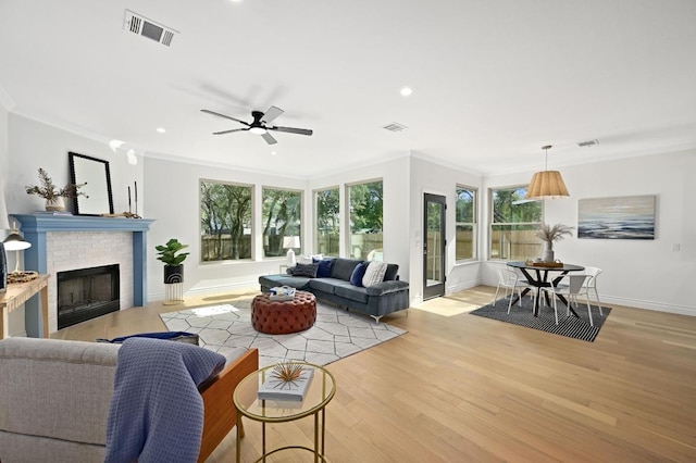 8902 Rustic Cv, Austin, TX 78717 - living room featuring crown molding, recessed lighting, light wood finished floors, a brick fireplace, and a ceiling fan