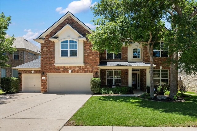 2500 Melekhin Bnd, Cedar Park, TX 78613 - view of front of home with a front lawn, driveway, a garage, and brick siding