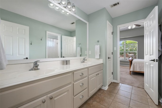 2500 Melekhin Bnd, Cedar Park, TX 78613 - bathroom with connected bathroom, double vanity, tile patterned floors, and ceiling fan