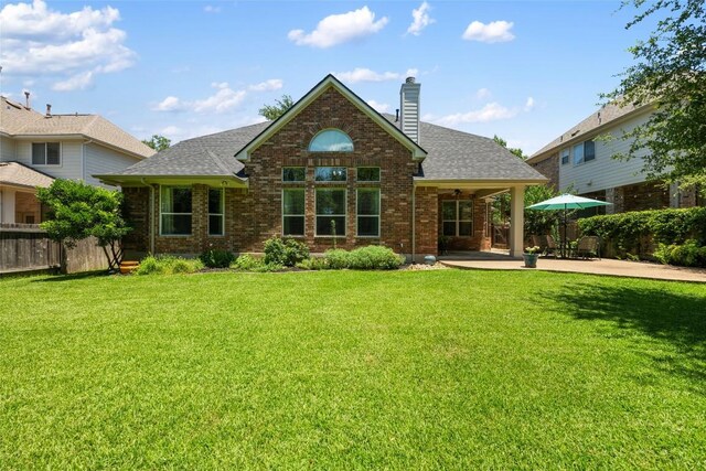 2500 Melekhin Bnd, Cedar Park, TX 78613 - back of property featuring a patio area, roof with shingles, a chimney, and brick siding