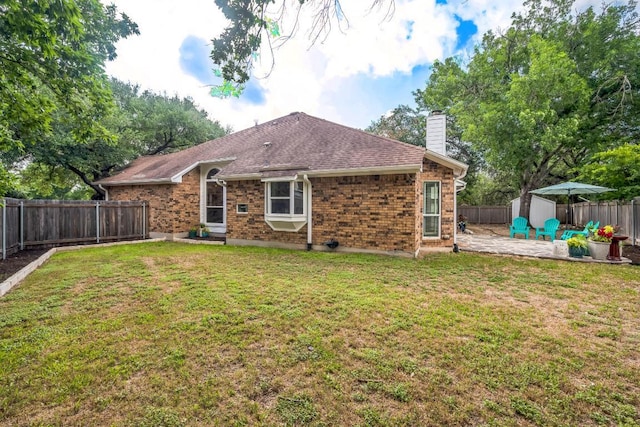 10506 Orourk Ln, Austin, TX 78739 - back of property featuring a patio, a fenced backyard, a storage unit, a chimney, and brick siding