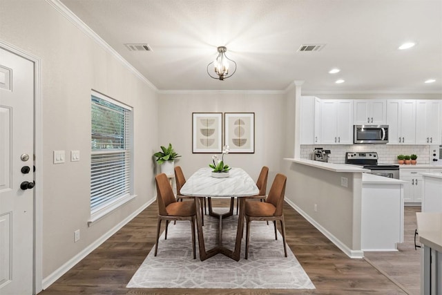 1113 Lott Ave, Austin, TX 78721 - dining room with crown molding, a chandelier, dark wood-type flooring, and recessed lighting