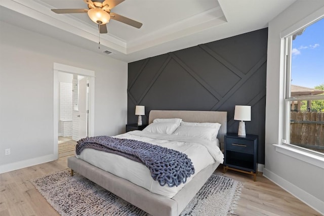 3101 Maysilee St, Austin, TX 78728 - bedroom with a decorative wall, wood finished floors, a tray ceiling, a ceiling fan, and ensuite bathroom