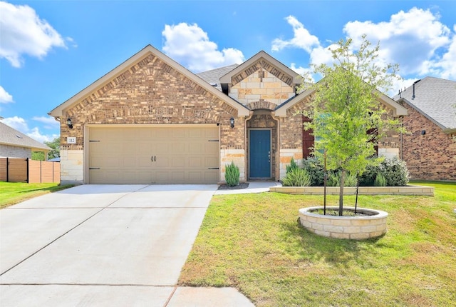 112 Silver Ridge Dr, Georgetown, TX 78633 - french country style house featuring an attached garage, driveway, stone siding, and brick siding