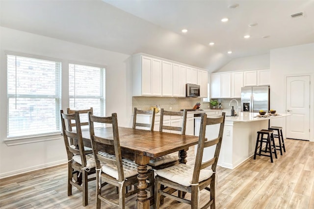 112 Silver Ridge Dr, Georgetown, TX 78633 - dining room with light wood-style floors, recessed lighting, and vaulted ceiling