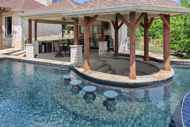 22126 Briarcliff Dr, Spicewood, TX 78669 - outdoor pool featuring a gazebo, area for grilling, a bar, and a patio area
