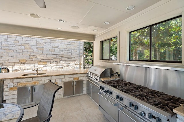 22126 Briarcliff Dr, Spicewood, TX 78669 - view of patio / terrace featuring a sink and exterior kitchen