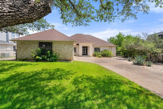 22126 Briarcliff Dr, Spicewood, TX 78669 - view of front of house with stone siding, a shingled roof, and driveway