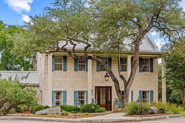 1660 W Mccarty Ln, San Marcos, TX 78666 - view of front facade featuring stone siding, a metal roof, and a standing seam roof