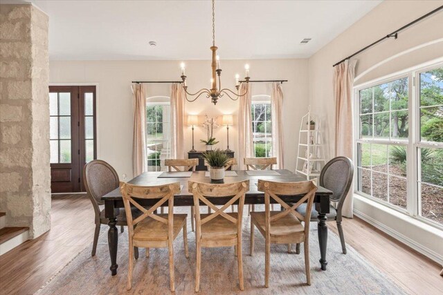 1660 W Mccarty Ln, San Marcos, TX 78666 - dining area featuring a chandelier, plenty of natural light, and light wood finished floors