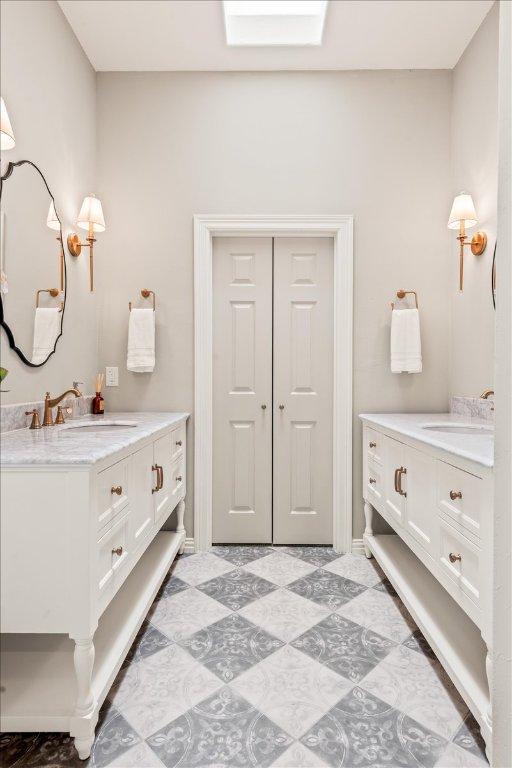 1660 W Mccarty Ln, San Marcos, TX 78666 - bathroom featuring two vanities and tile patterned floors