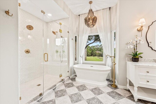 1660 W Mccarty Ln, San Marcos, TX 78666 - bathroom featuring a soaking tub, a shower stall, tile patterned floors, and vanity