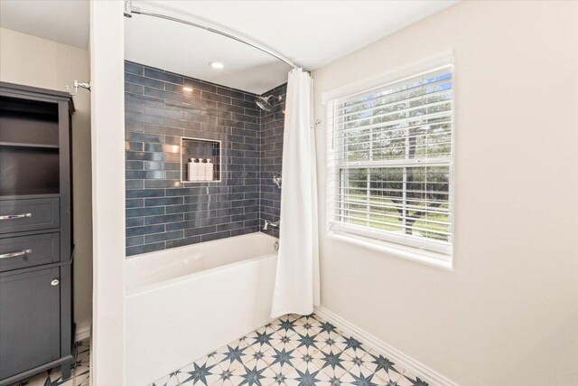 1660 W Mccarty Ln, San Marcos, TX 78666 - bathroom with healthy amount of natural light and shower / bathtub combination with curtain