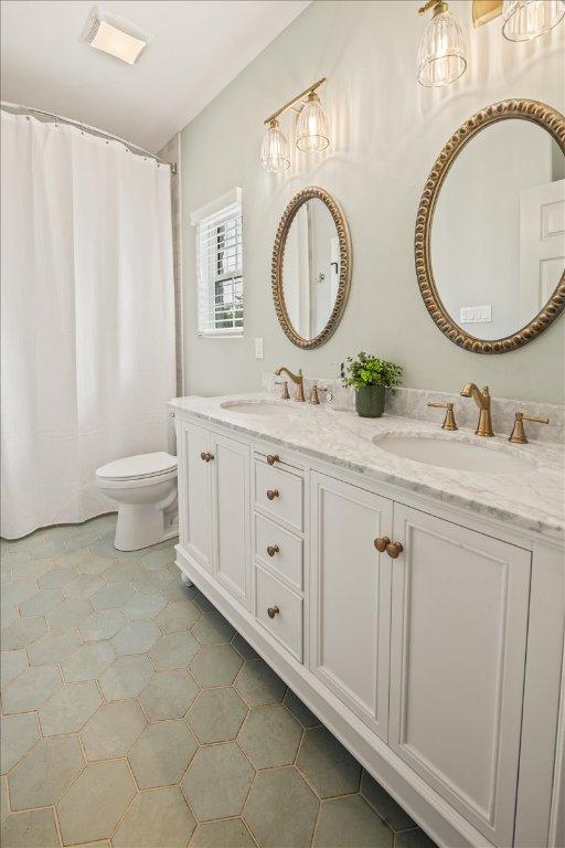 1660 W Mccarty Ln, San Marcos, TX 78666 - full bathroom with double vanity and toilet