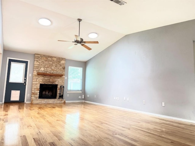 4202 Kilgore Ln, Austin, TX 78727 - unfurnished living room with wood finished floors, ceiling fan, lofted ceiling, and a stone fireplace