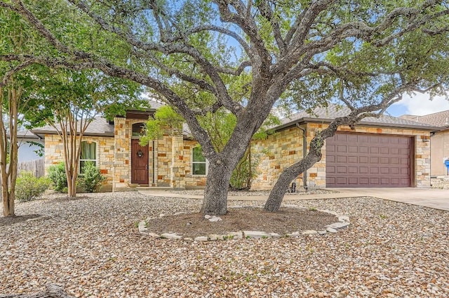 5501 Hitching Post, Lago Vista, TX 78645 - view of front facade featuring stone siding, driveway, and a garage