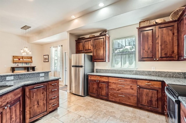 5501 Hitching Post, Lago Vista, TX 78645 - kitchen with appliances with stainless steel finishes, a chandelier, hanging light fixtures, dark stone countertops, and recessed lighting