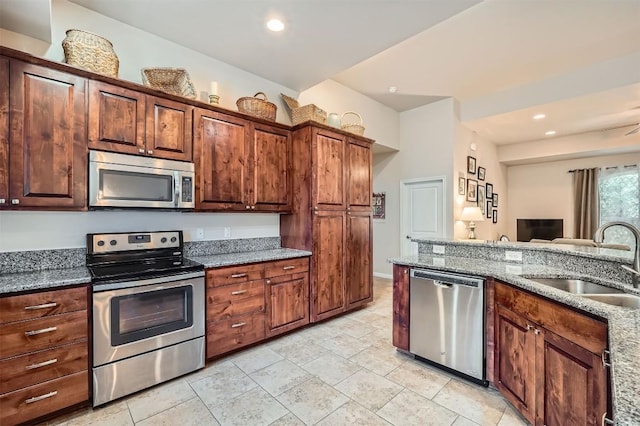 5501 Hitching Post, Lago Vista, TX 78645 - kitchen with stainless steel appliances, stone countertops, recessed lighting, and light tile patterned floors