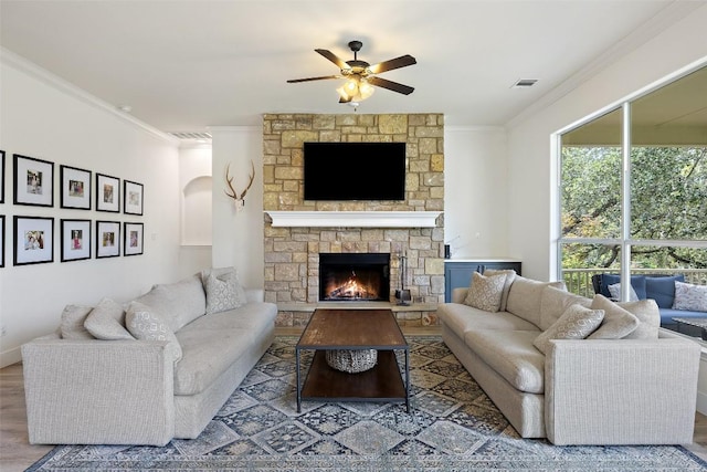 300 Errol Dr, Spicewood, TX 78669 - living area with a ceiling fan, ornamental molding, a fireplace, and wood finished floors