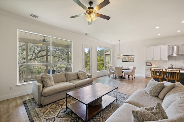 300 Errol Dr, Spicewood, TX 78669 - living area with ornamental molding, a ceiling fan, plenty of natural light, light wood finished floors, and recessed lighting