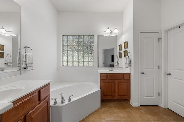 300 Errol Dr, Spicewood, TX 78669 - bathroom featuring a bath, two vanities, and tile patterned floors