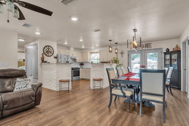 2008 Paige St, Georgetown, TX 78626 - dining room featuring wood finished floors, ceiling fan, recessed lighting, and a textured ceiling