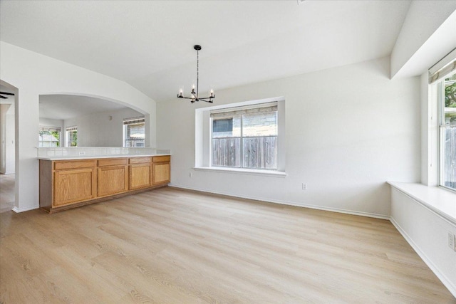 3659 Nolan Ryan Blvd, Round Rock, TX 78665 - unfurnished dining area with light wood-type flooring, arched walkways, a chandelier, healthy amount of natural light, and lofted ceiling