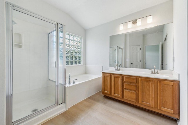 3659 Nolan Ryan Blvd, Round Rock, TX 78665 - full bathroom featuring wood finished floors, a shower stall, double vanity, a bath, and lofted ceiling