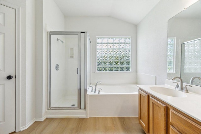 3659 Nolan Ryan Blvd, Round Rock, TX 78665 - bathroom with wood finished floors, a stall shower, vanity, a bath, and vaulted ceiling