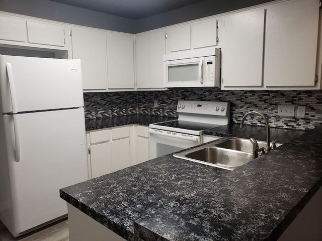1221 W Hopkins St Unit 11, San Marcos, TX 78666 - kitchen with white appliances, backsplash, white cabinetry, wood finished floors, and a peninsula