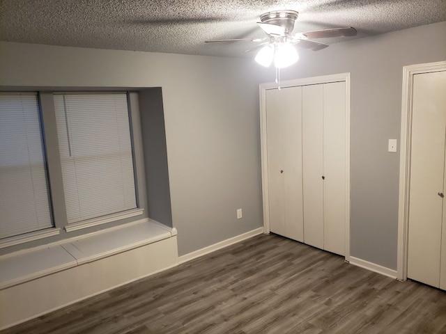 1221 W Hopkins St Unit 11, San Marcos, TX 78666 - unfurnished bedroom with wood finished floors, a textured ceiling, a ceiling fan, and a closet
