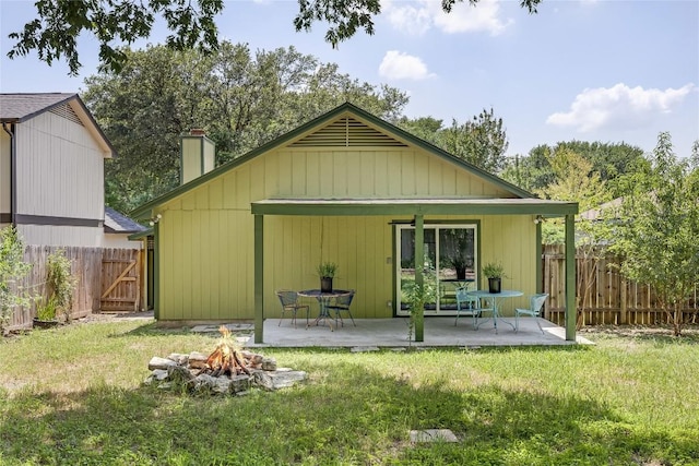 1406 Byers Ln, Austin, TX 78753 - rear view of house with a fire pit, a chimney, a gate, a patio area, and a fenced backyard
