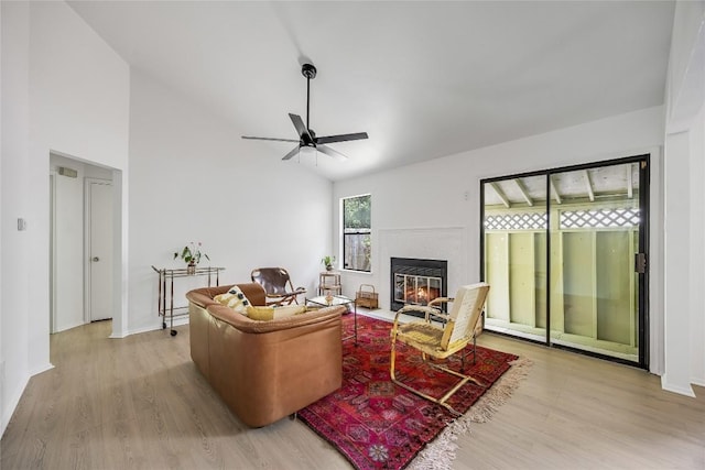 1406 Byers Ln, Austin, TX 78753 - living room featuring light wood-style flooring, a ceiling fan, a fireplace with flush hearth, and high vaulted ceiling