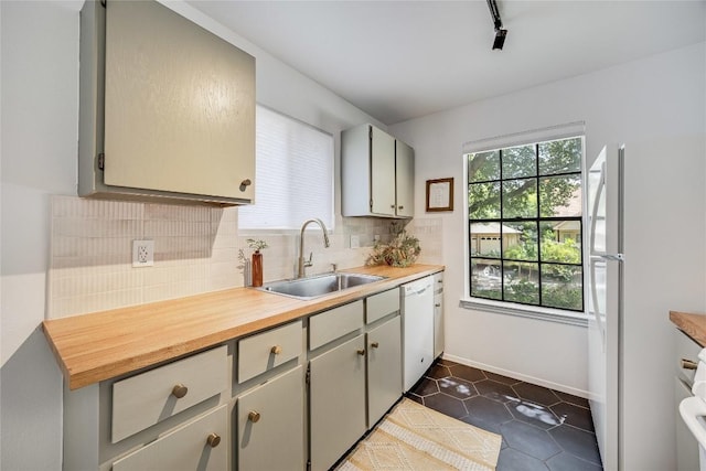 1406 Byers Ln, Austin, TX 78753 - kitchen with white appliances, backsplash, light countertops, and dark tile patterned floors